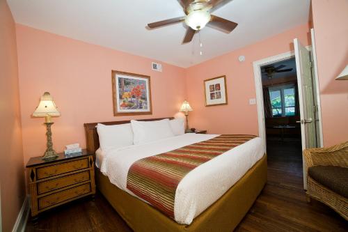 a bedroom with a bed and a ceiling fan at DeSoto Beach Gardens in Tybee Island