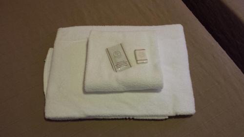 a pile of white towels on a table at Hotel Mosaic in Rome
