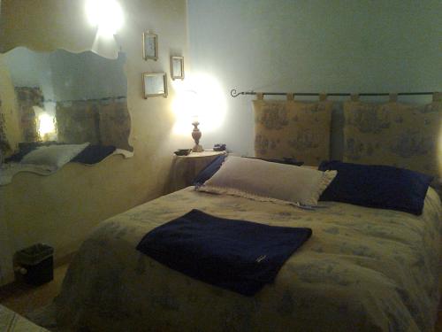 a bedroom with a bed with a blue blanket on it at Bed And Breakfast Di Manu in Taglio di Po