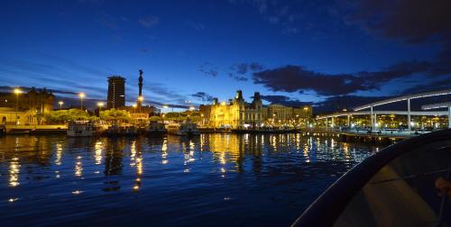 a city at night with lights on the water at Southern Cross in Barcelona