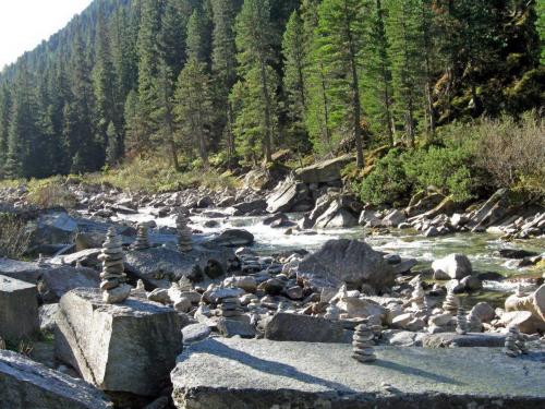 a river with rocks and trees on a mountain at Landhaus Tirol in Zellberg