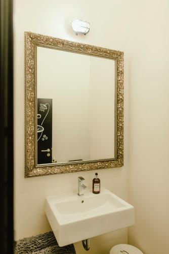 a bathroom with a sink and a mirror at Wake Up Wellness Hostel in Brno