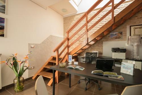 an office with a desk and a staircase at Civico 64 Bed & Breakfast in mansarda in Palmi