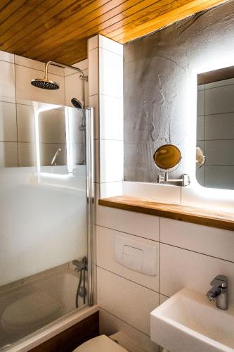 a bathroom with a shower and a toilet and a sink at Nant Morzine in Morzine