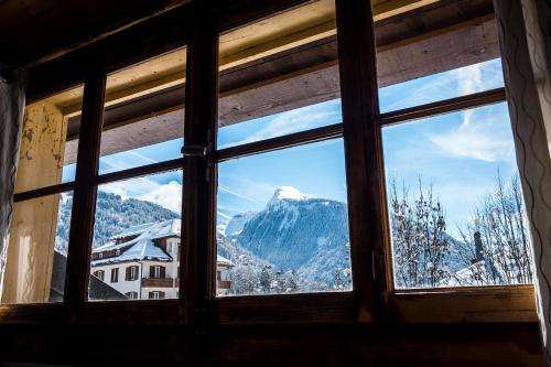 a window with a view of a mountain at Nant Morzine in Morzine