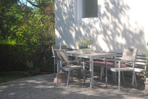 una mesa y sillas frente a una casa en Pension Etschland, en Tirolo
