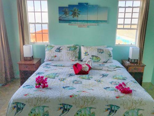 a bedroom with a bed with flowers on it at Ocean View Villas in Jost Van Dyke