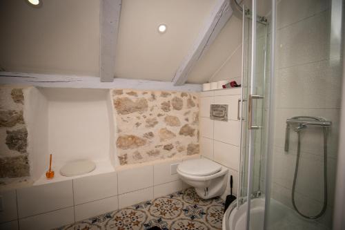 a bathroom with a toilet and a glass shower at Rooms Epidaurus in Dubrovnik