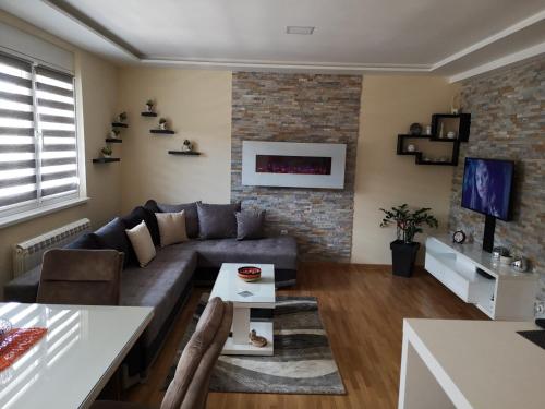 a living room with a couch and a table at Apartman Maximus Zlatibor in Zlatibor