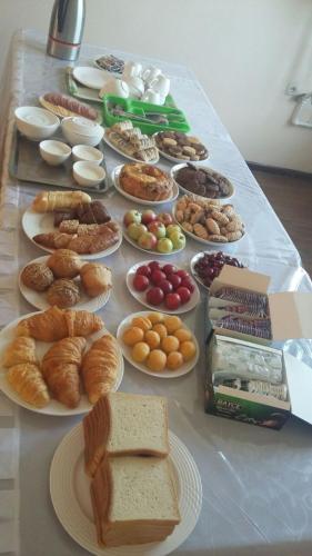 a table full of different types of bread and pastries at Hotel "GRAND WAY" in Tashkent