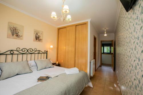 a bedroom with a large bed in a room at Casa Galiñanes in Portonovo
