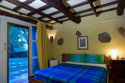 a bedroom with a bed and a sliding glass door at Prà de Mandè in Viano