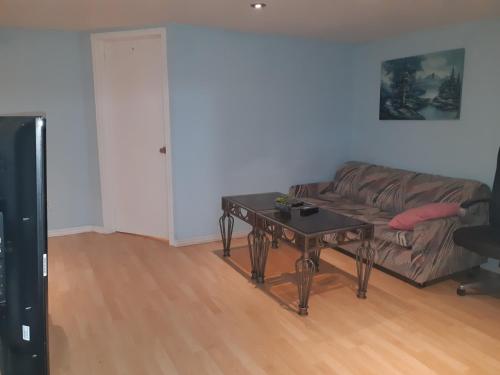 uma sala de estar com um sofá e uma mesa em McMaster Accommodations em Hamilton