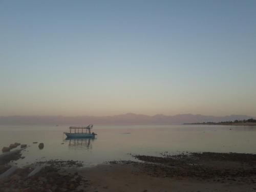 a boat sitting in the water on a lake at Sina Star Camp in Nuweiba