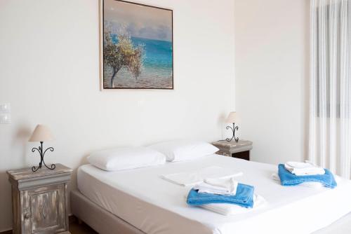 a bedroom with a bed with two towels on it at La Sapienza in Methoni