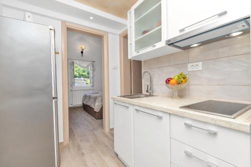 a kitchen with white cabinets and a counter top at Apartment Kalle in Kotor