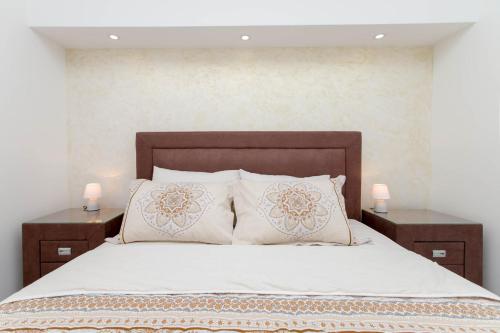 a bedroom with a large bed with two night stands at Apartment Kalle in Kotor