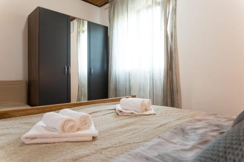 a bedroom with two towels on a bed in front of a mirror at Villa Nava in Benkovac