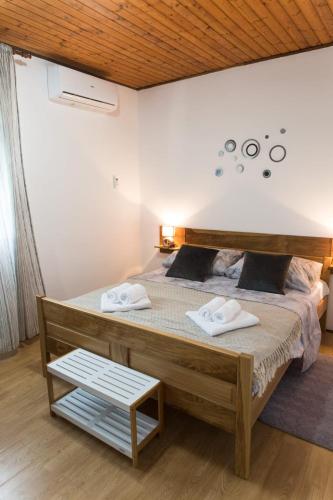 a bedroom with a large bed with two towels on it at Villa Nava in Benkovac
