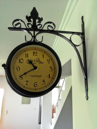 a clock hanging from the ceiling of a building at Villa Watamu in Trzęsacz