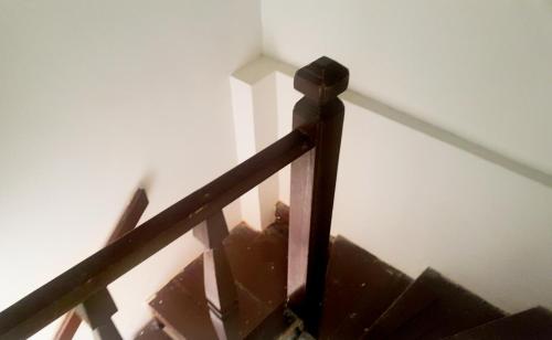 a close up of a wooden railing on a stairs at Oludeniz Hostel in Fethiye