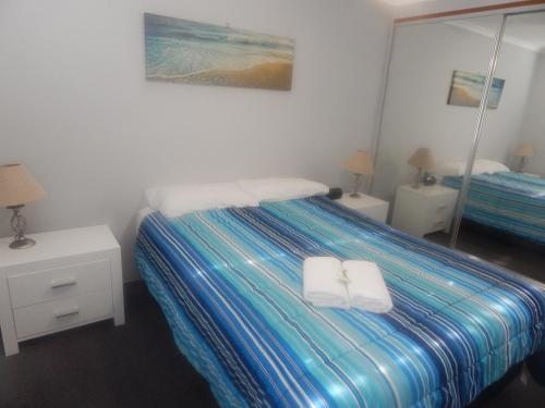 a hotel room with a bed and a desk at Tranquil Shores in Caloundra
