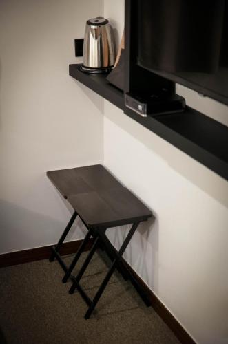a small black table in front of a tv at Hotel Lumia Myeongdong in Seoul