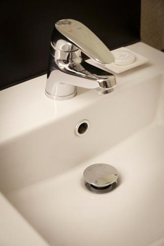 a bathroom sink with a chrome faucet on it at Hotel Lumia Myeongdong in Seoul