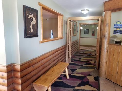 a hallway with a wooden bench on a wall at Days Inn by Wyndham Sandpoint in Ponderay