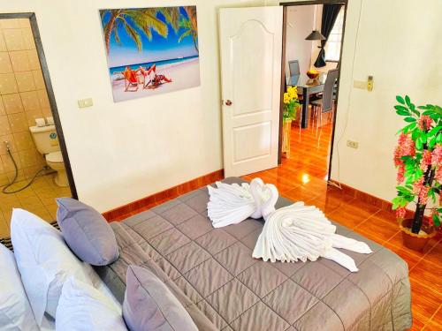 a bedroom with a bed with pillows on it at Thai Orange Villas in Jomtien Beach