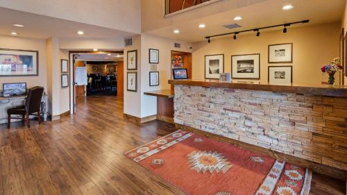 a living room with a bar and a brick wall at Inn at Santa Fe, SureStay Collection by Best Western in Santa Fe