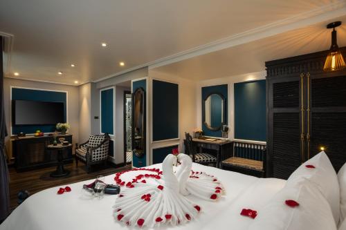 a bedroom with a bed with a swan decoration on it at Hanoi Esplendor Hotel and Spa in Hanoi