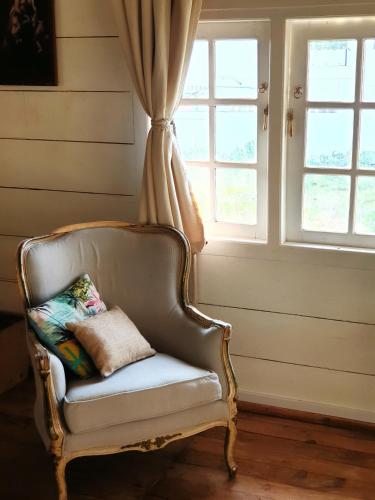 a chair sitting in a room with a window at Memo's Beach in Nilaveli