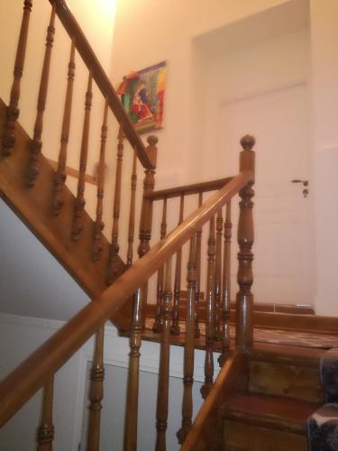a staircase in a home with wooden railings at The Magic Mountain in Tsapournia