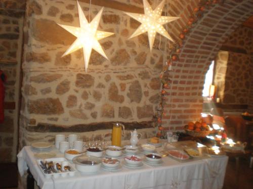 a table with food on it with stars on the wall at Nimbus Guesthouse in Kastoria