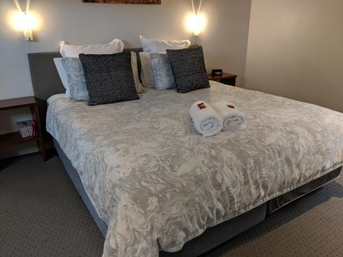 a bedroom with a bed with two towels on it at Hanover Bay Apartments in Albany
