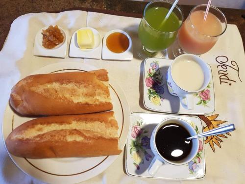 a table with two plates of food and drinks at Chambre d'hôtes Valiha in Ivato
