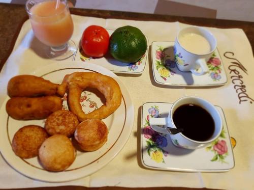 a table with plates of food and a cup of coffee at Chambre d'hôtes Valiha in Ivato