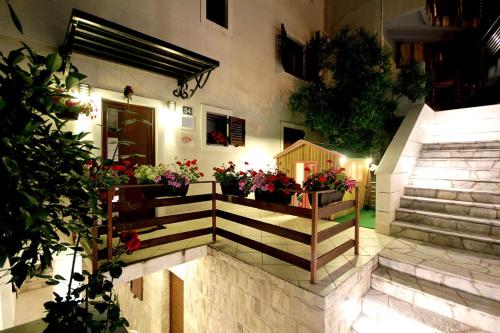 a building with some flowers in a house at Apartments Ardura in Petrovac na Moru