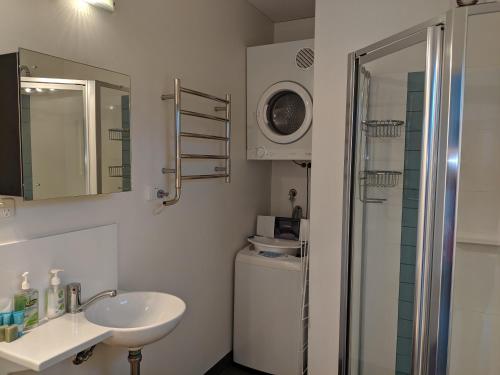 a bathroom with a sink, mirror, and toilet at Hanover Bay Apartments in Albany