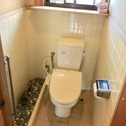a bathroom with a toilet in a small room at まるで一国一城の主 佐藤邸 in Nichinan