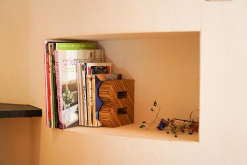 a book shelf with books and a figurine on it at Akari no Yado Okabe in Shibukawa