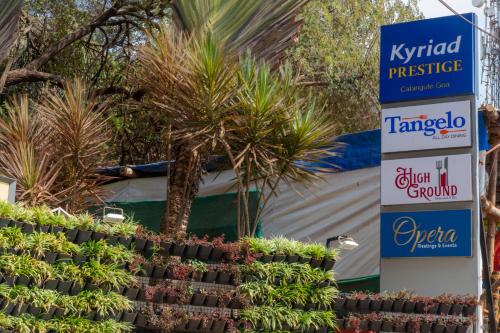a sign that says kyrid prestige and a plant display at Kyriad Prestige Calangute Goa by OTHPL in Calangute