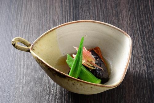 a bowl with food in it on a table at Akari no Yado Okabe in Shibukawa