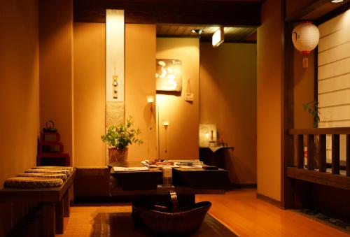 a living room with a table and a hallway with a stair at Akari no Yado Okabe in Shibukawa