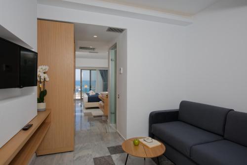 a living room with a couch and a table at Archipelagos Hotel in Rethymno Town