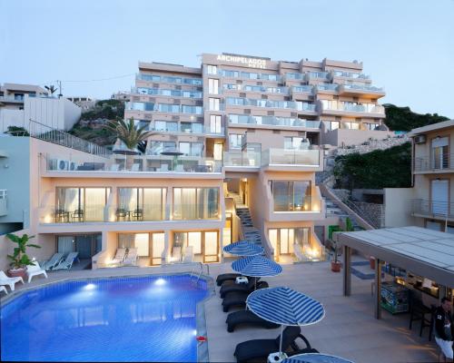 a hotel with a swimming pool in front of a building at Archipelagos Hotel in Rethymno Town
