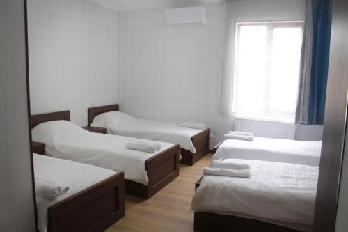 a room with four beds and a window at Bagration in Gori