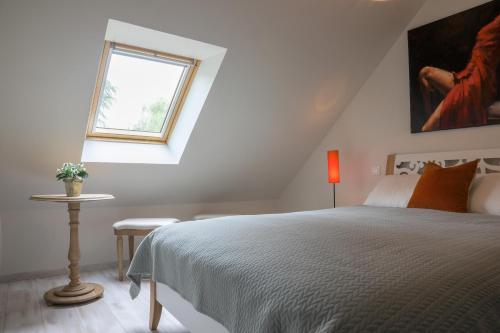 a white bedroom with a bed and a window at Country house - La Mercerie in Continvoir
