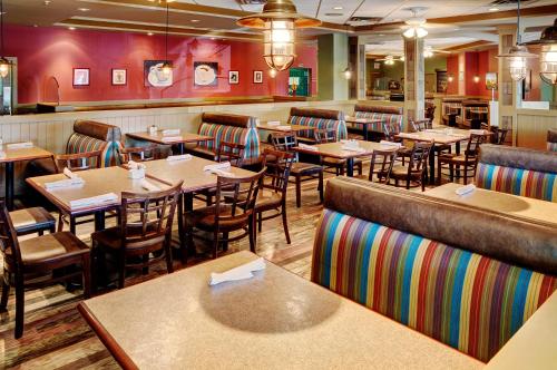 a restaurant with tables and chairs and a bar at Chateau Nova Kingsway in Edmonton